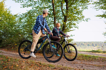 Fototapeta premium Happy young couple riding bicycles outdoor