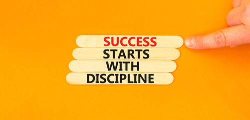 Success starts with discipline symbol. Concept words Success starts with discipline on beautiful wooden sticks. Beautiful orange background. Business success starts with discipline concept. Copy space