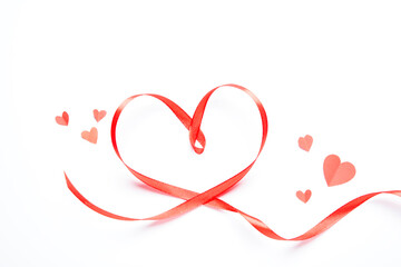 Red heart-shaped ribbon on a white background