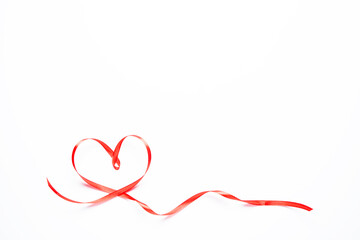 Red heart-shaped ribbon on a white background