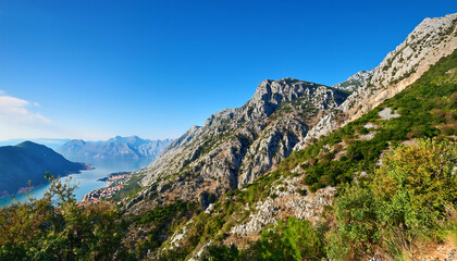  A sunlit mountain slope with greenery and rocks near the Bay of Kotor, Montenegro, under a _1(247)