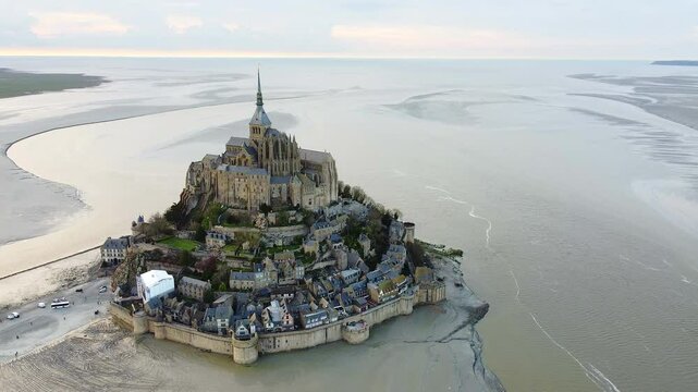 Aerial view of the iconic Mont Saint-Michel, a historic town with Gothic architecture located on a small island in Normandy, France. 