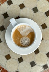Close-Up of Freshly Brewed Coffee on a Patterned Tile Table