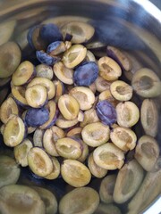 Halved Plums Prepared in a Cooking Pot