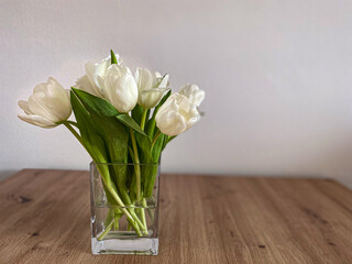 bouquet of white tulips in glass vase