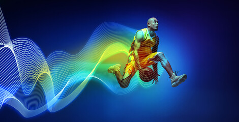 Focused man in yellow uniform, basketball player in motion during game, jumping with ball against blue background with motion line effect. Concept of sport, action, competition. Banner, ad. Modern art