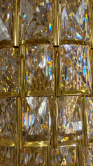 Close-up view of a crystal light fixture, showcasing brilliant refractions and colorful light spectrums, ideal for luxury interior design themes