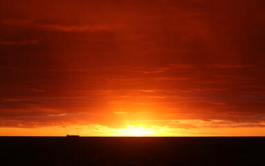 Photos of an unusual autumn sunset at sea
