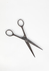 old metal scissors on white background
