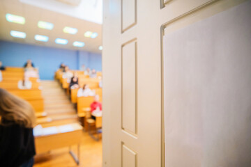 Blurred background of the examination room with undergraduate students inside