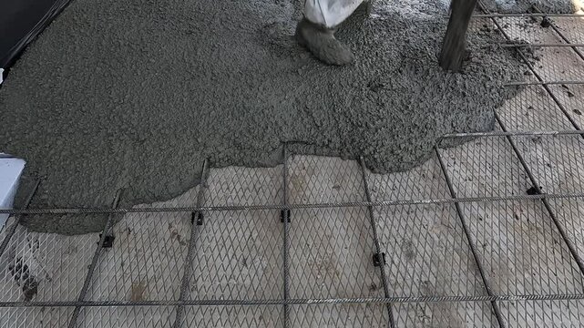 Concreting, laying concrete, concrete works in close-up. Slow motion. View of the construction site. A close-up view of the pouring of concret