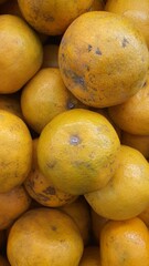 Close up pile of tasty fresh oranges sold at the market as a background.	