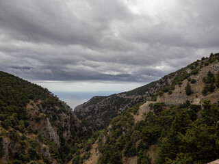 Montain road near Hora Sfakion, Crete, Grece. Libian sea in the distance on a cloudy day.