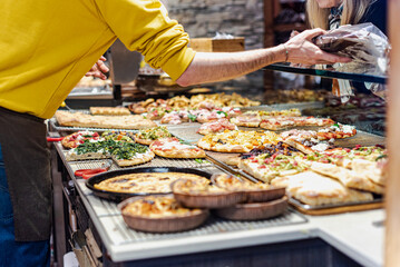 Pizza by the slice in an italian bakery.