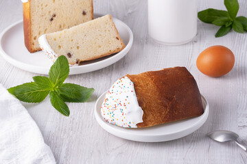 Delicious sweet bread with sprinkles served alongside a slice and fresh mint on a wooden table
