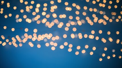 Fototapeta premium golden bokeh lights scattered on blue background
