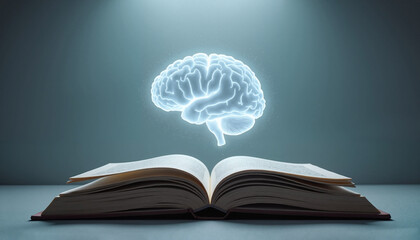 Open book with a glowing brain illustration above it, symbolizing knowledge and creativity