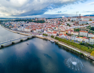 Aerial view of Coimbra city old town on the hill. Panoramic drone cityscape and Mondego River, Portugal