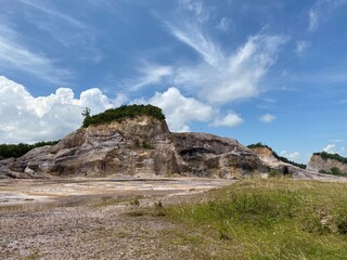 landscape with rocks, a blue sky,  in a hidden valley in the country side of South East Asia