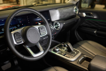 Closeup of a modern car steering wheel with control buttons for technology and convenience