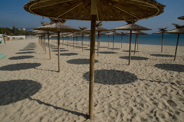 beach with umbrella s empty beach in autumn 