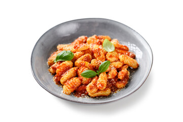 Traditional Italian potato gnocchi with tomato sauce, parmesan cheese and fresh basil leaves isolated on white background