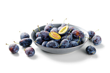 Plate of fresh ripe plums isolated on white background