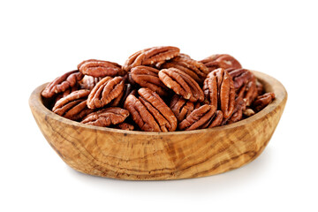 Pecan nuts in wooden bowl isolated on white background