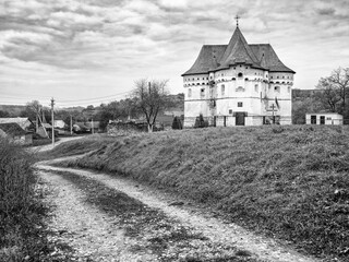 vintage style of photo of old orthodox church on hill in Ukrainian village Sutkivtsy