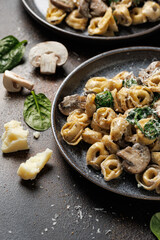 Chestnut Mushrooms and spinach tortellini served with parmesan cheese