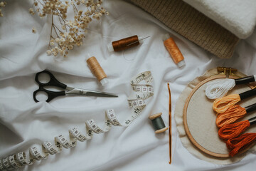  threads of different brown colors with needles, scissors, canvas with floss and measuring tape 