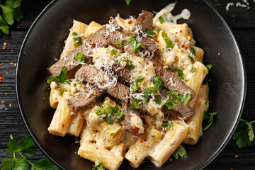 Philly cheese steak pasta in black bowl