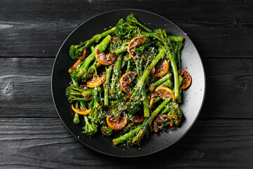 Tenderstem broccoli and charred lemon served in black plate