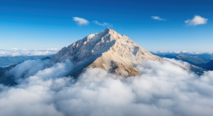 Majestic snow-capped mountain peak above the clouds