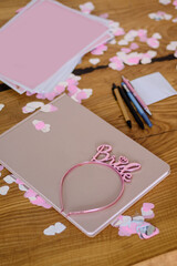 Pink hair band, albums and confetti on bachelorette party.