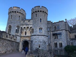 Historic castle with stone towers under a blue sky