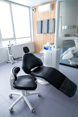 Empty stomatologist workplace consulting room with tools for teeth treatment