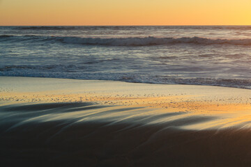 Sand beach at sunset, tranquil scene, copy space for the text