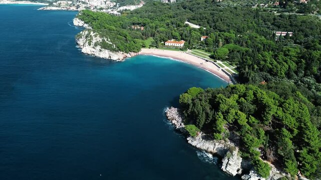 Aerial view of St. Nicholas Island and Budva and Becici town from afar. The Adriatic coast in Montenegro. Clear turquoise water. A calm seascape. Sea resort is popular among tourists