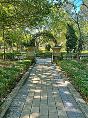 Entrance of outdoor park, trees, green plants, gardening path in public  park