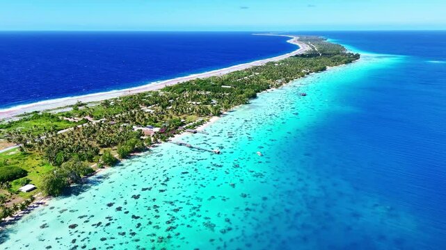 Drone Tuamotu atoll. Aerial view Fakarava island in French Polynesia. Tropical beach, palm trees and clear ocean water. Exotic travel destination for honeymoon, cruise and scuba diving. 