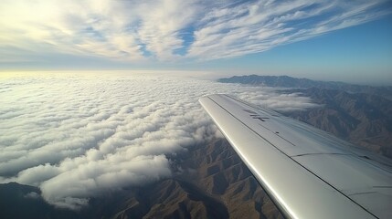 View from the plane: Clouds above the mountains, clouds and sky, clouds in the foreground, clouds...