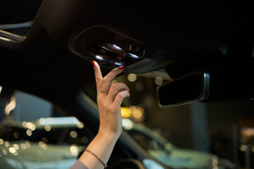 Discover a modern car interior with a stylish hand adjusting mirror for added functionality