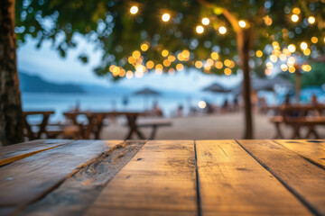 Empty wooden table top with blurred beach bar restaurant in sunset. Table top with copy space for product advertising