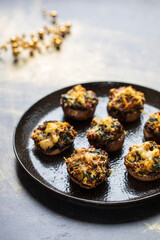 Stuffed mushroom canapes with spinach, sun dried tomatoes and cheese
