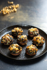 Stuffed mushroom canapes with spinach, sun dried tomatoes and cheese