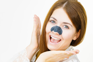 Woman applying pore strips on nose