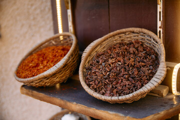 Woven baskets filled with aromatic spices and dried herbs in a traditional market in Dubai, symbolizing cultural richness and trade heritage