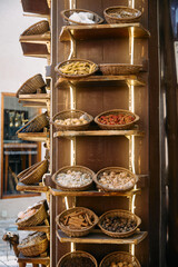 Display shelves with a variety of aromatic spices and dried goods in a traditional market in Dubai, reflecting the richness of local trade culture