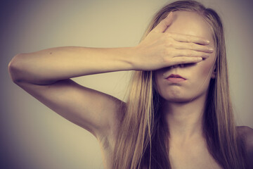 Woman covering her eyes with hand